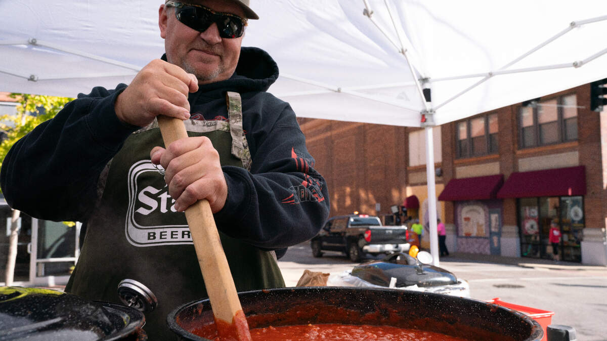 Alex Cortez stirs a pot of chil during the annual Chili Cookoff in Belleville, Ill. on Oct. 6, 2023.