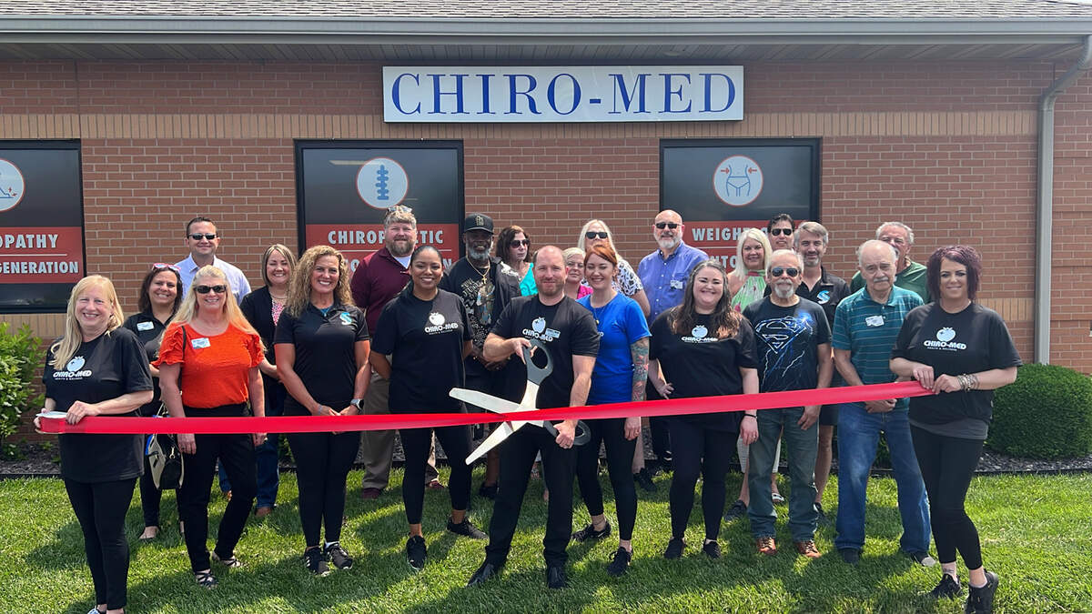 ChiroMed II held a grand reopening in O’Fallon Thursday, May 18. Pictured cutting the ribbon is Dr. Chad Weber.