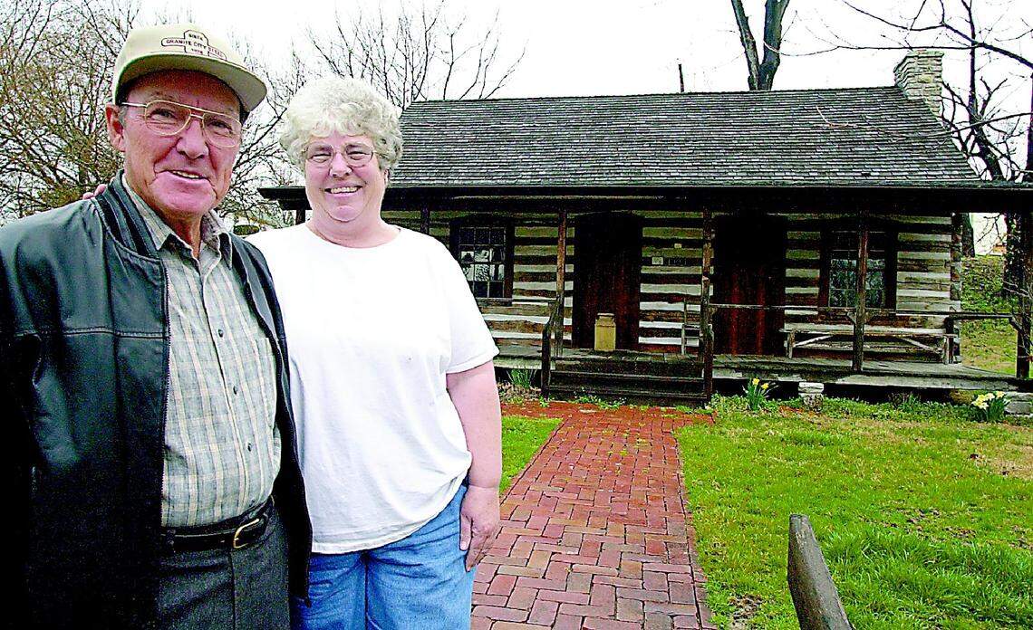 Bob and Joyce Williams in front of the Yanda Log Cabin, Glen Carbon.