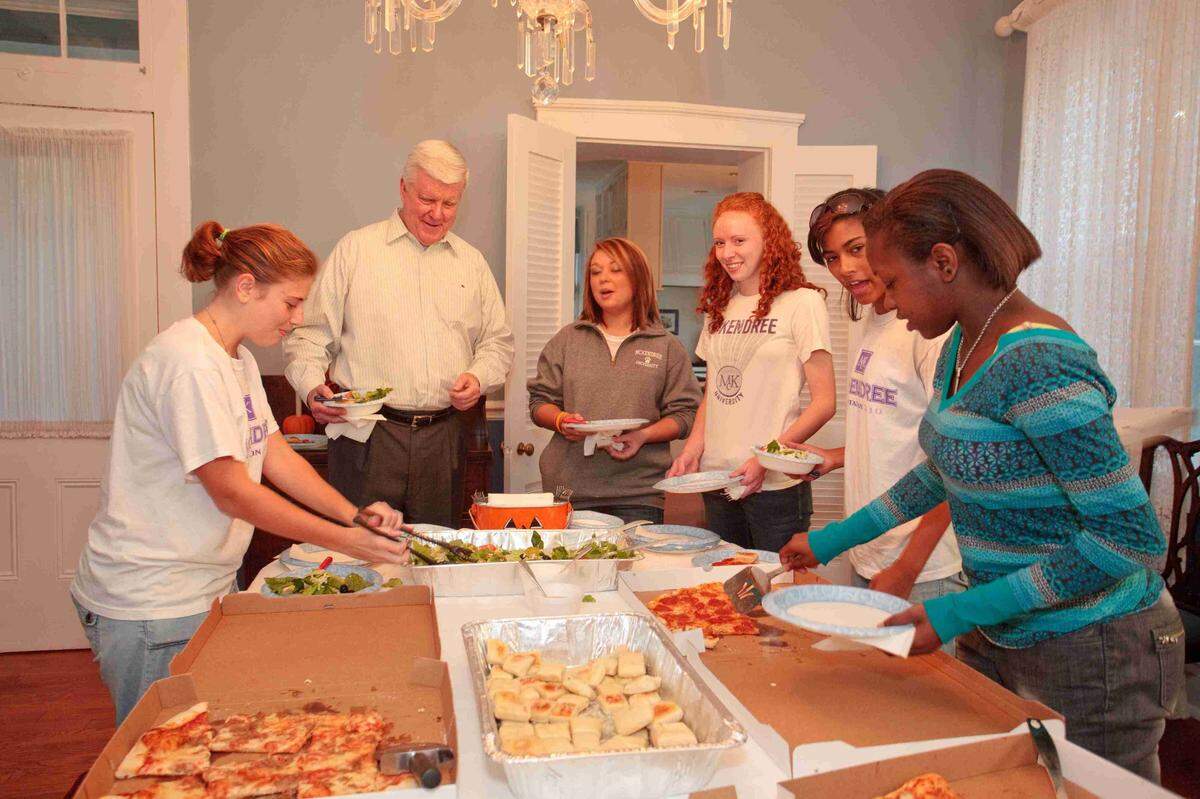 James Dennis regularly invites dorm residents and student groups to his McKendree University residence for Pizza with the President parties, including this one in 2010.