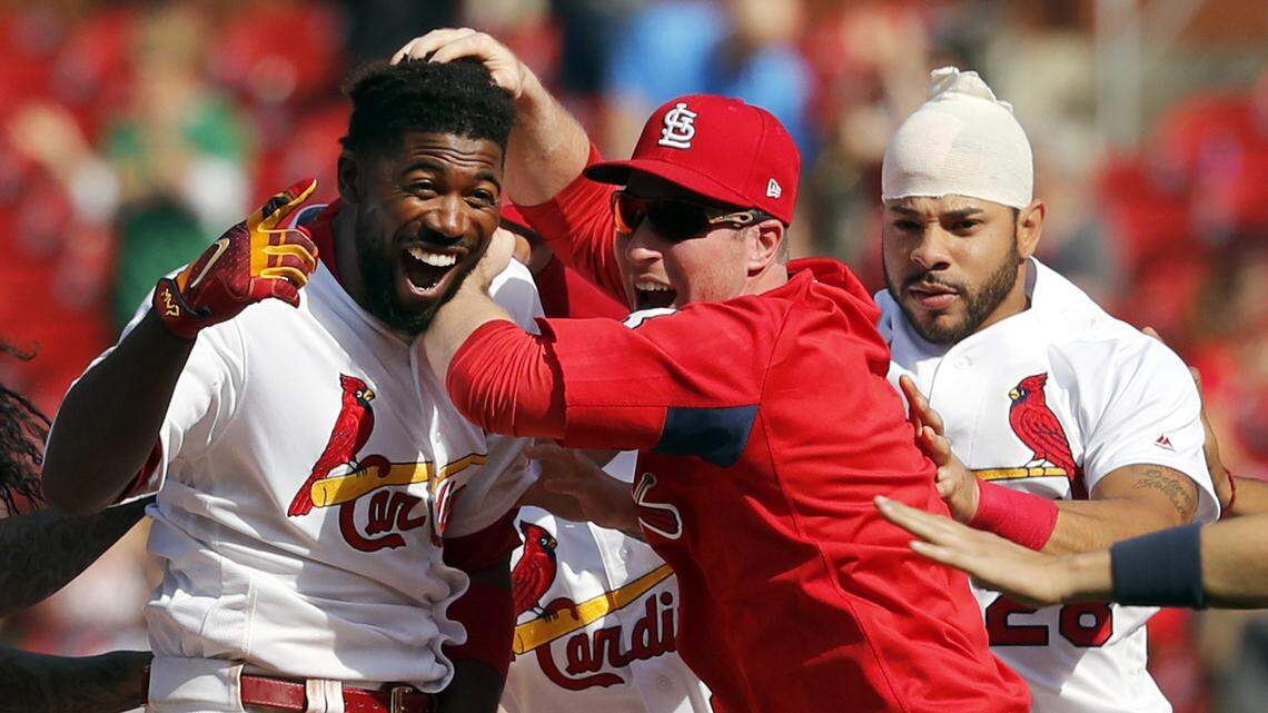Dexter Fowler and teammates Jedd Gyorko and Tommy Pham celebrate a walkoff hit that gave the Cardinals an early-season series win against the New York Mets.