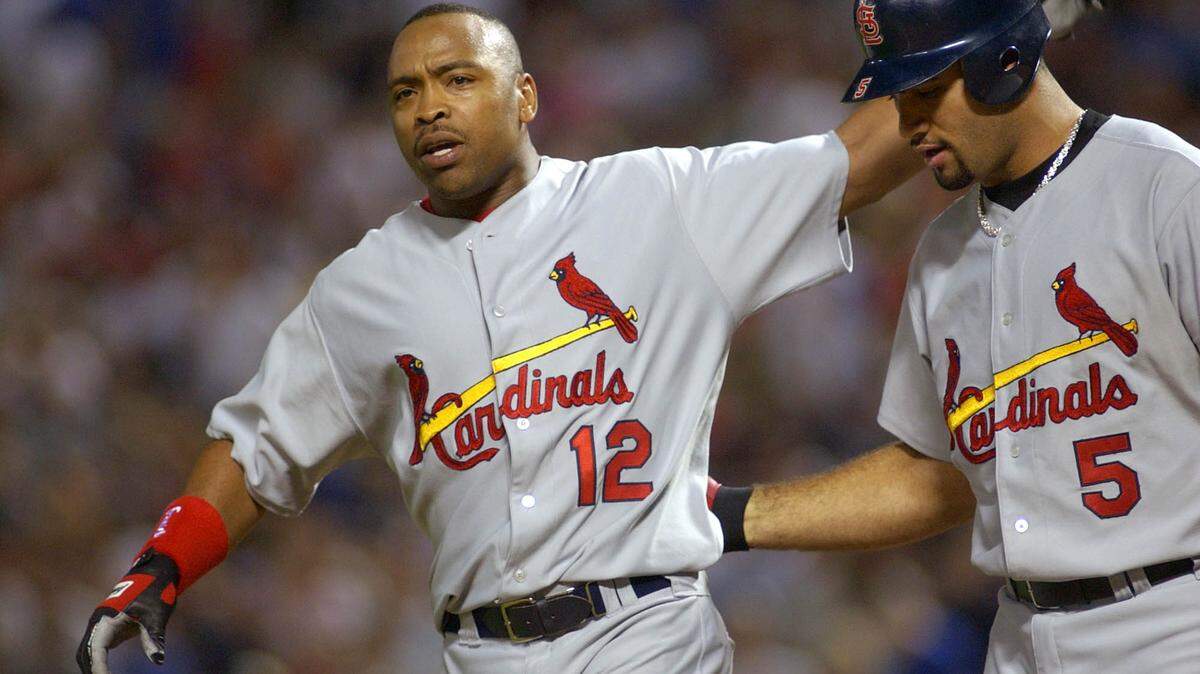 St. Louis Cardinals’ Ray Lankford (12) walks off the field with teammate Albert Pujols in the seventh inning against the Texas Rangers on Friday, June 11, 2004, in Arlington, Texas.