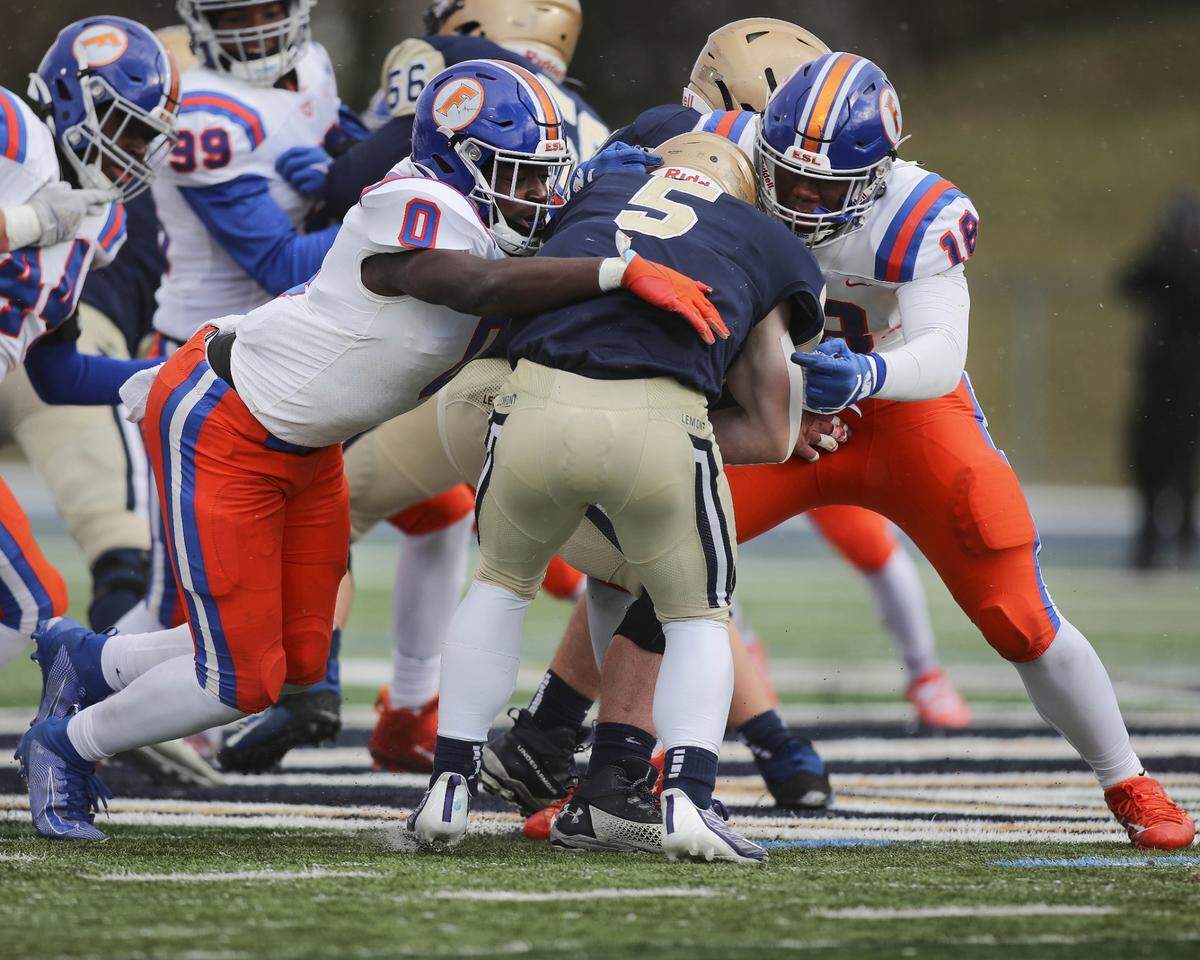 East St. Louis defensive linemen Roger MaCary and Austin Franklin stuff Lemont’s Nate Wrublik at the line of scrimmage during the IHSA Class 6A state semifinals. The Flyers won 32-29 and now will face Crystal Lake Prairie Ridge in the state championship game.