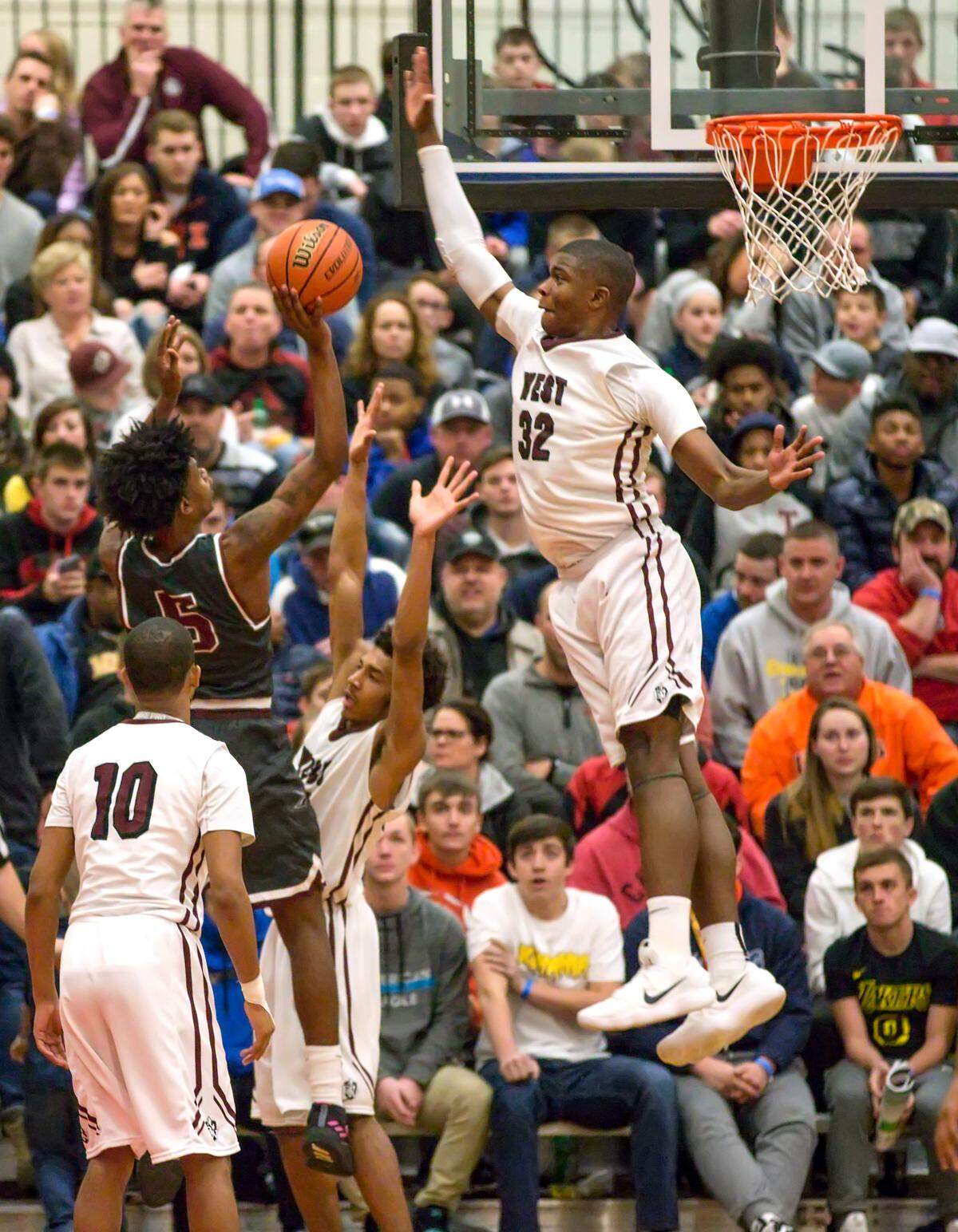 E.J. Liddell blocks a shot during the Belleville East Chick-fil-A Classic last winter.