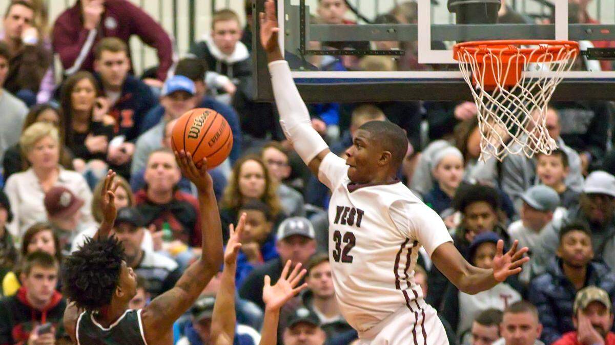 E.J. Liddell blocks a shot during the Belleville East Chick-fil-A Classic last winter.