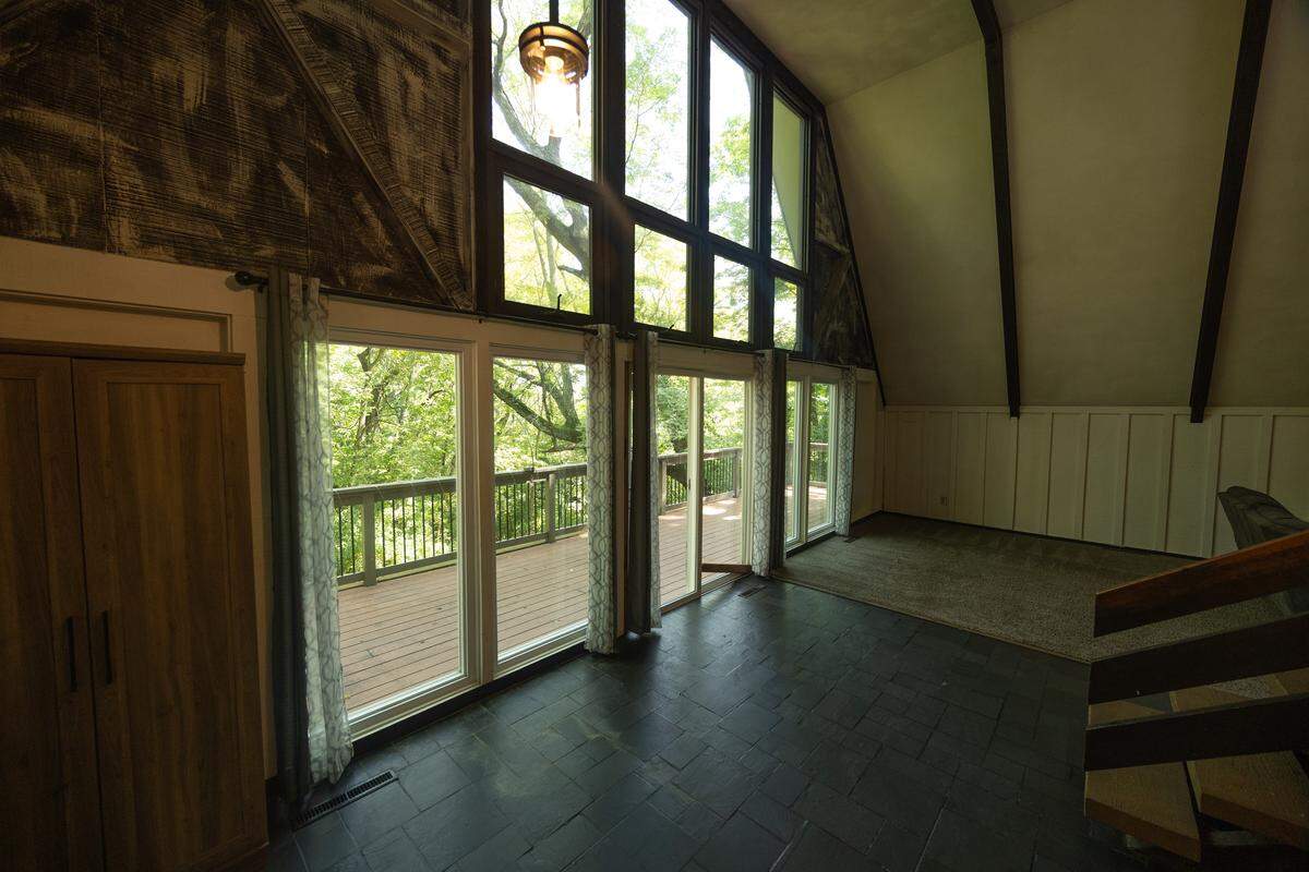 The rear of the home is covered in large windows, allowing for a flood of natural light.