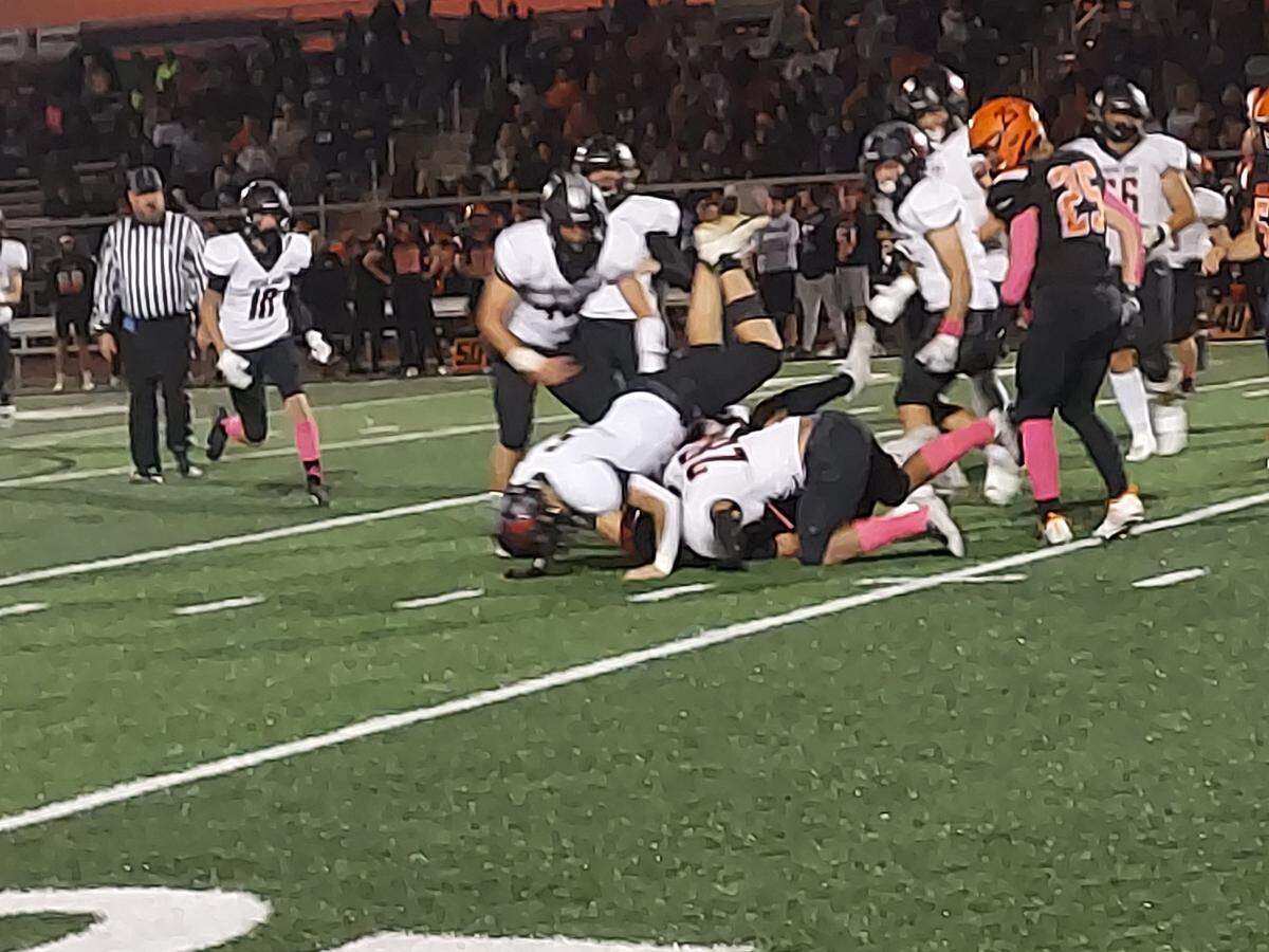 Highland defenders Ethan Greenwald (bottom left) and Travis Porter (bottom right) take down Waterloo’s Koby Osterhage after a short gain during Friday night’s Mississippi Valley Conference showdown. Highland ultimately posted a 49-10 road victory.