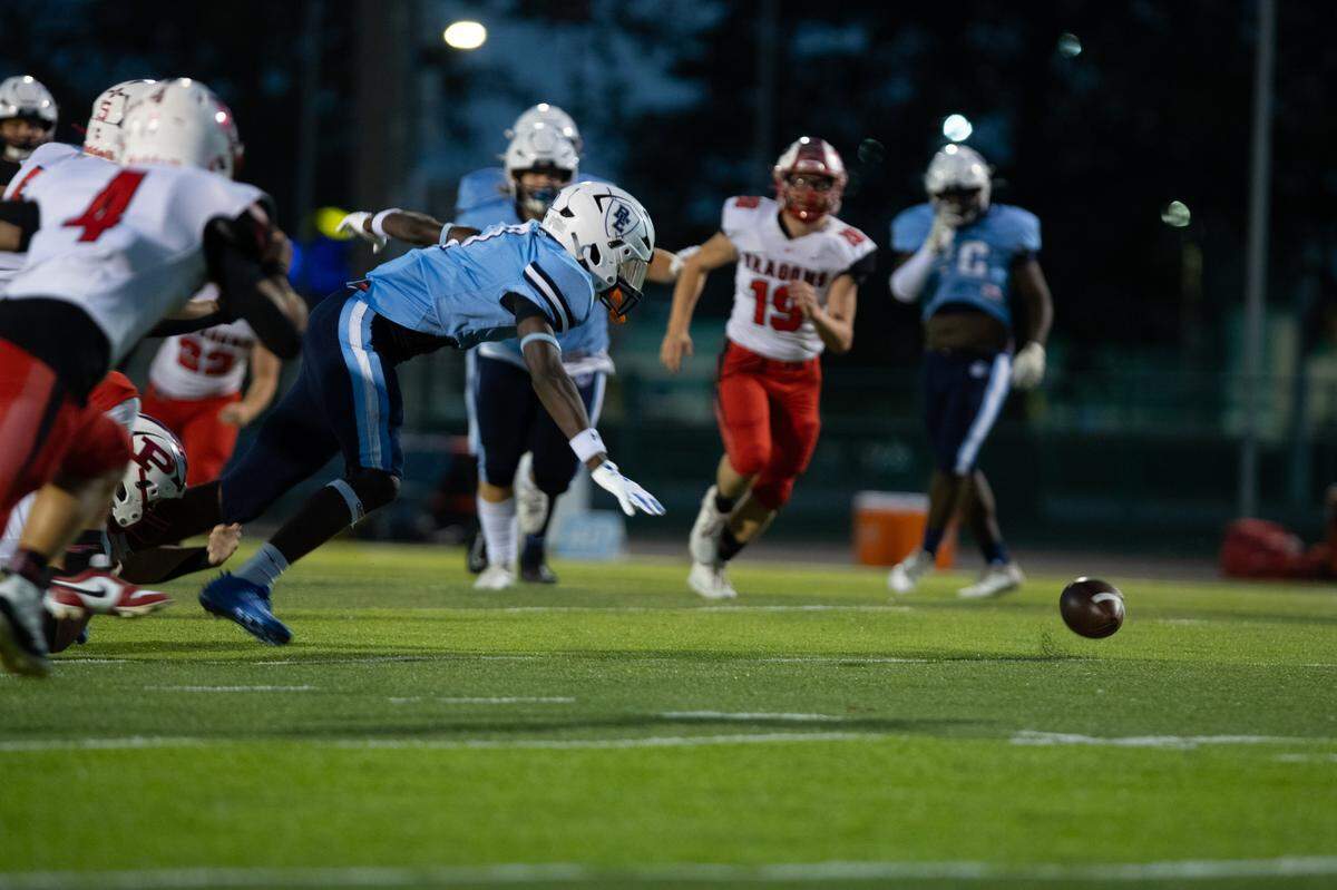 Belleville East scrambles for a fumbled punt during a sluggish first half of an eventual overtime victory over Pekin at Charlie Woodford Field on Sept. 6, 2024.