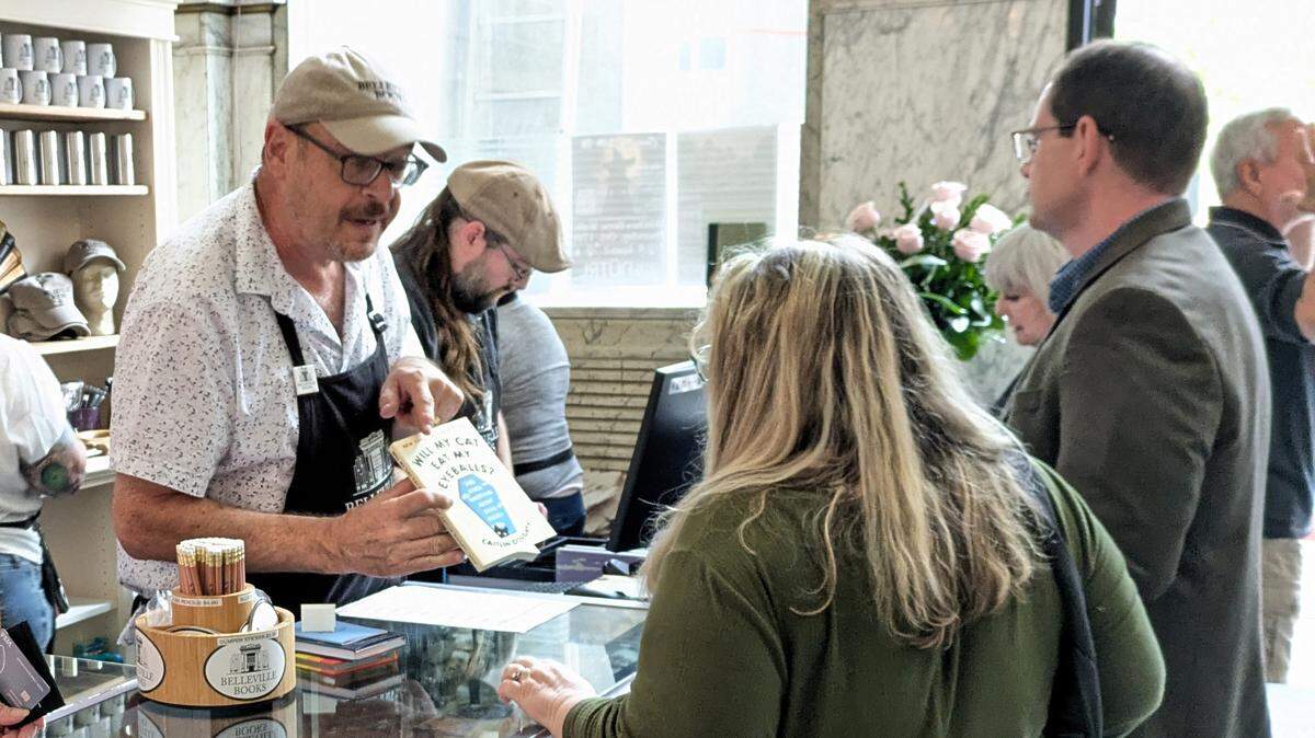 Belleville Books owner Rob Eckman talks books at the checkout counter.