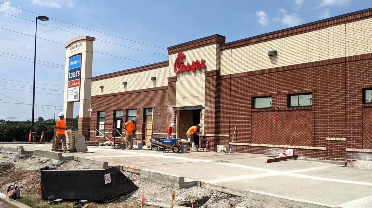 Construction crew focus on brickwork at Chick-fil-A at Green Mount Commons in Belleville during a remodeling project in June. A location in Fairview Heights underwent a similar update in August and reopens next week.