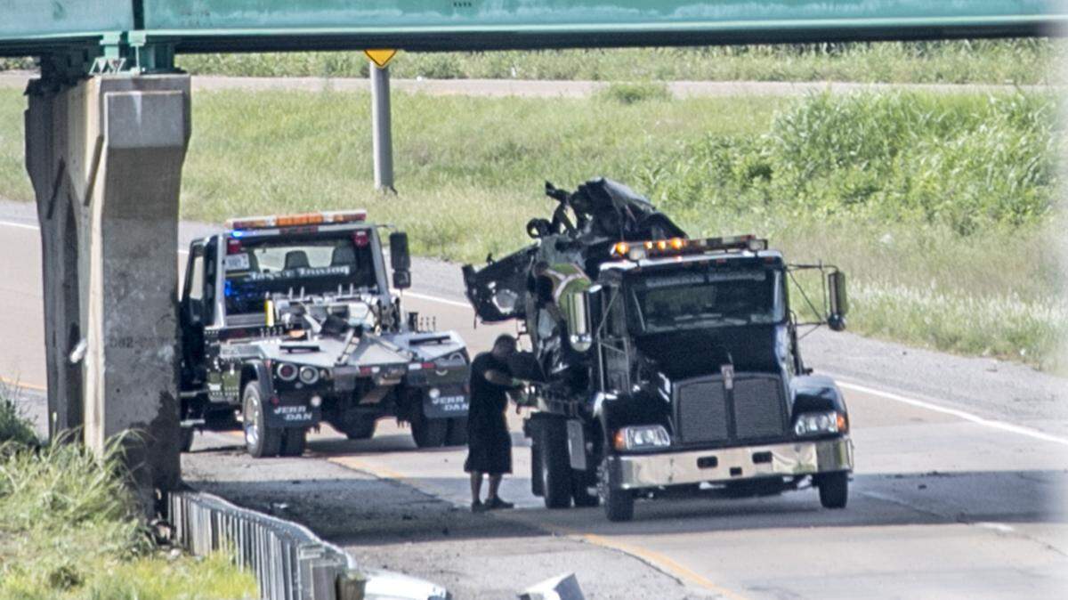 Tow truck operators remove a vehicle from a single-car crash on Westbound Illinois 15 at Old St. Louis Road in Belleville.