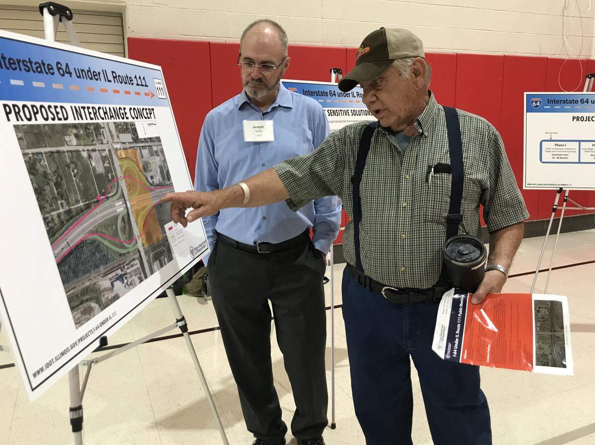 Fairview Heights resident Carl Weissert points out the location of his farmland to Joe Galloy, manager of the Illinois Department of Transportation’s cultural resources unit, at a open house hosted Tuesday by IDOT at James Avant Elementary School in Washington Park.