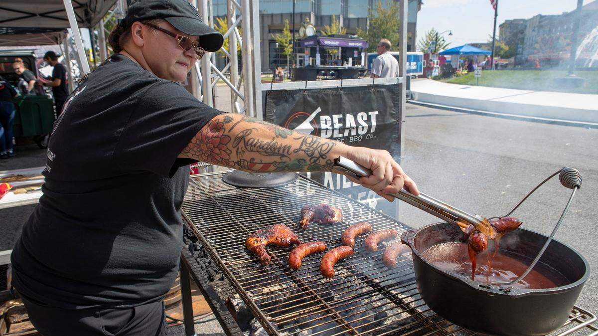 Loren Osequera, with Beast BBQ, prepares Stag Beer brats and smoked chicken leg quarters at Oktoberfest in Downtown Belleville. The 41st annual Belleville Oktoberfest continues Saturday from 11 a.m. to 11 p.m. with food, live music, entertainment, games and beer.