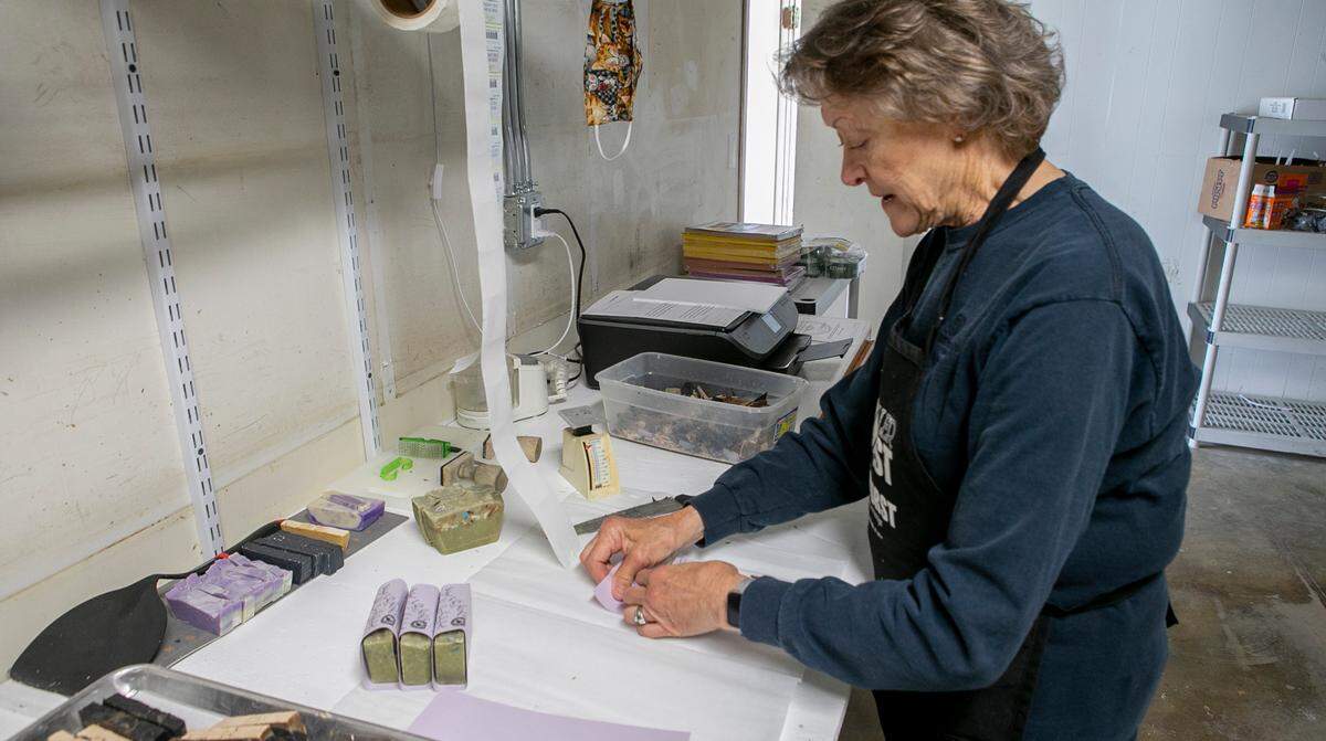 Nancy Bakay packages Waterfall Glen Soap Co. soaps at the company’s new headquarters on East Main Street in Belleville.