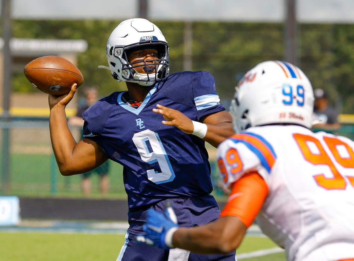 Belleville East quarterback Darron Millender Jr. drops back to pass the ball against visiting East St. Louis during Saturday’s Southwestern Conference game. The Lancers fell to the Flyers 57-0.