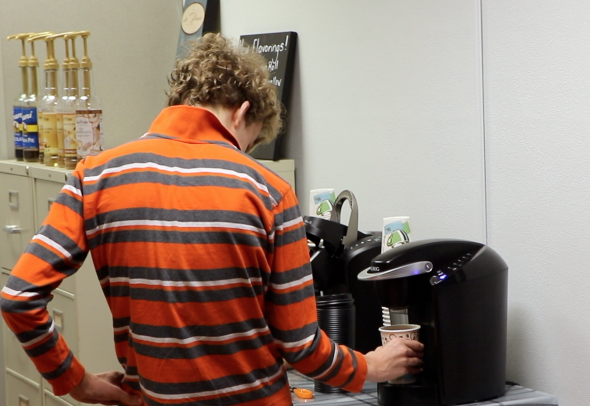 Highland High School student Jared Atwood makes coffee in a Keurig for students at the school’s new coffee shop run by special transitional experience program (STEP) students. The students take and prepare orders, handle money and interact with customers at the shop.