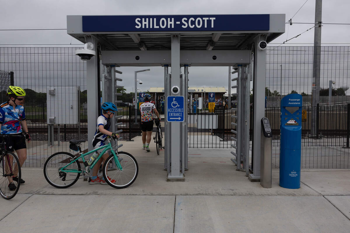 Bicyclists walk through the Shiloh-Scott MetroLink terminal to join the inaugural ride at the St. Clair County Transit District’s opening of its $6 million, 4.5-mile expansion of the MetroBikeLink Trail from the Scott-Shiloh MetroLink stop to MidAmerica Airport.