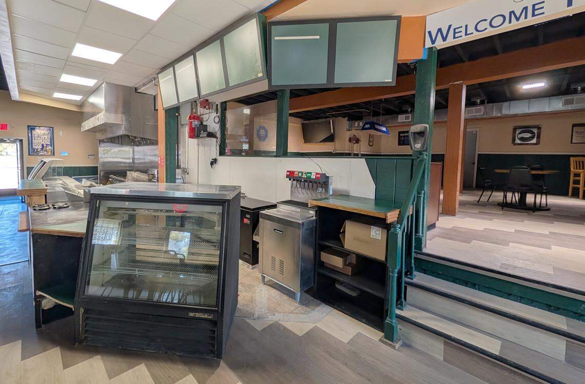 View of the kitchen/ordering counter at Schatze's Bar & Grill. At the right are the steps to the game room area.