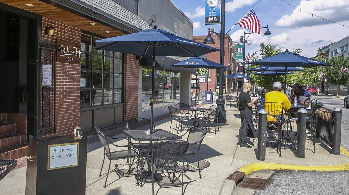 The Wine Tap in Belleville serves customers outside of their restaurant. They have patio seating in front and to the side of their building.