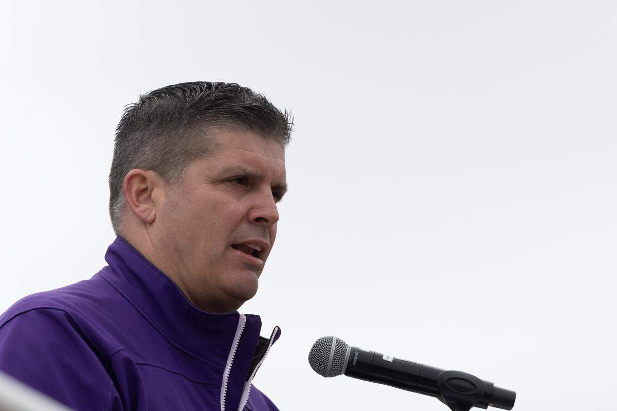 Collinsville Superintendent Mark B. Skertich speaks to a crowd in opposition to a proposed ban of Native American mascots in Illinois.
