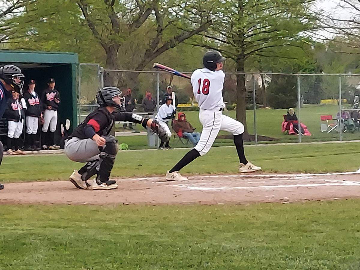 Highland outfielder Tyler Griesbaum rips a shot toward second base during a Mississippi Valley Conference game against rival Triad on Tuesday, May 2, at Glik Park in Highland. The Knights rallied late to defeat the Bulldogs 5-2.