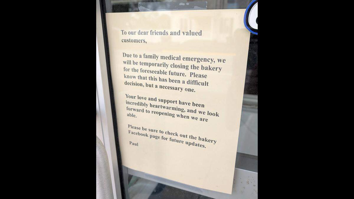 A notice on the door of Berkemann's Baker's Dozen in New Baden states the reason for its temporary closure.