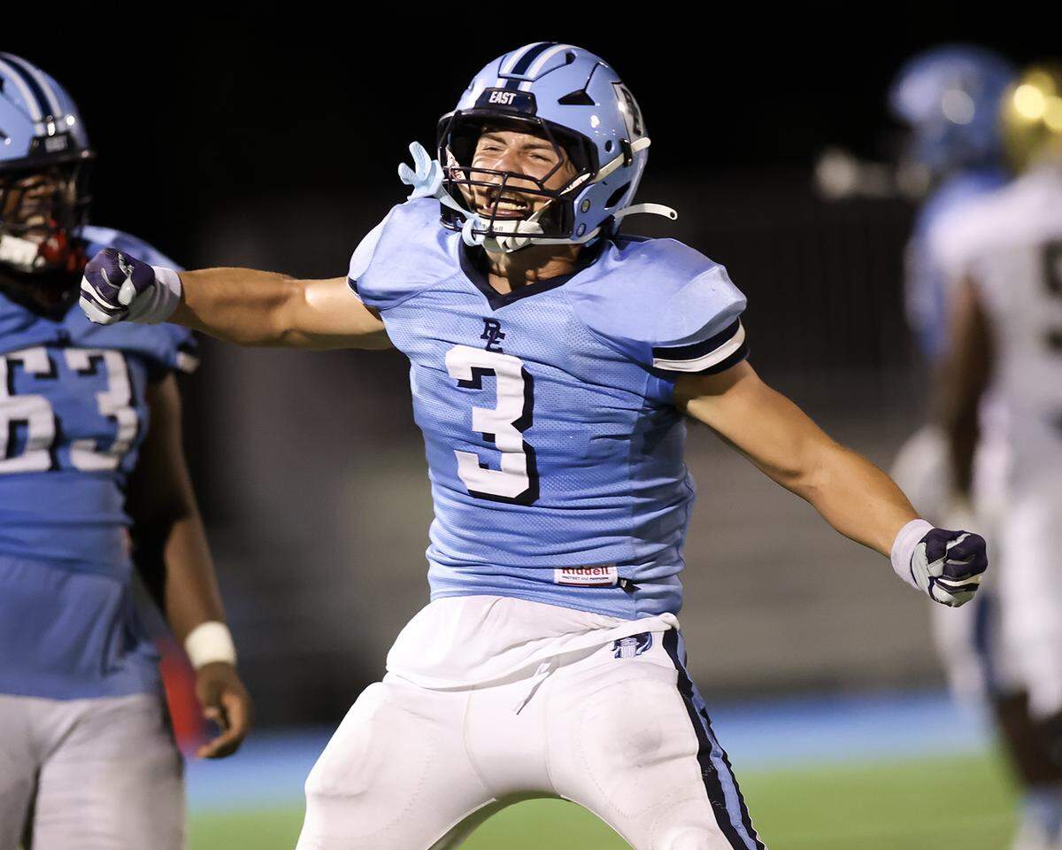 Belleville East's Killian Rauch shows his excitement after making a fourth down tackle to stop an Althoff drive during Friday night’s intracity matchup.