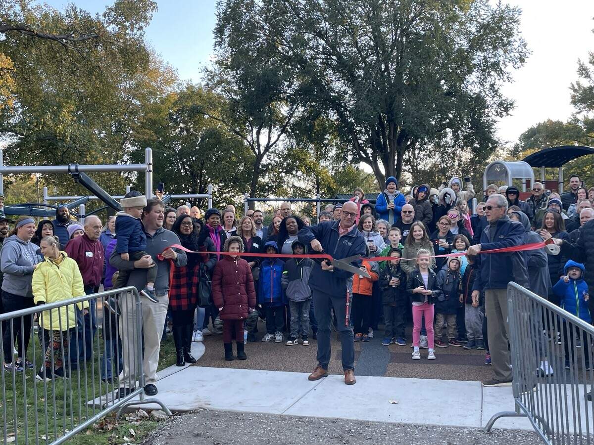 Patrick Christensen, superintendent of recreation, and his son Noah, join Andrew Dallner, department director (center), and Mayor Herb Roach, at a very chilly ribbon-cutting Oct. 30.