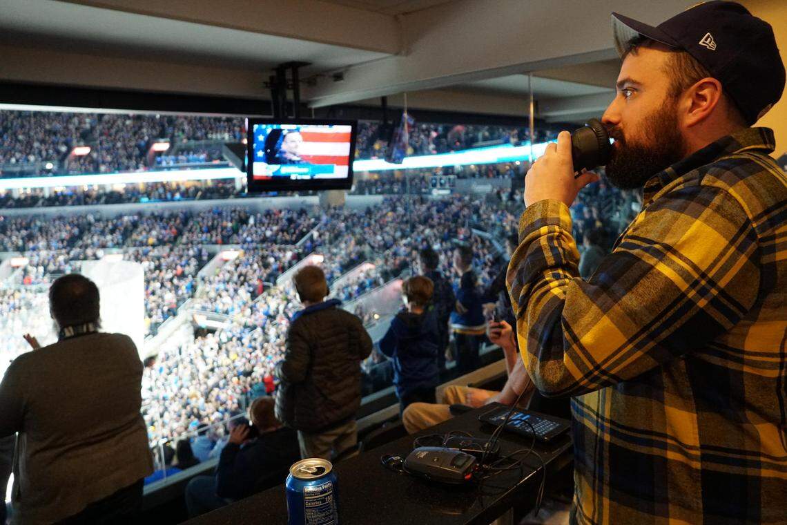 MindsEye volunteer Cory Sturdevant performs live audio description of a St. Louis Blues game at Enterprise Center.