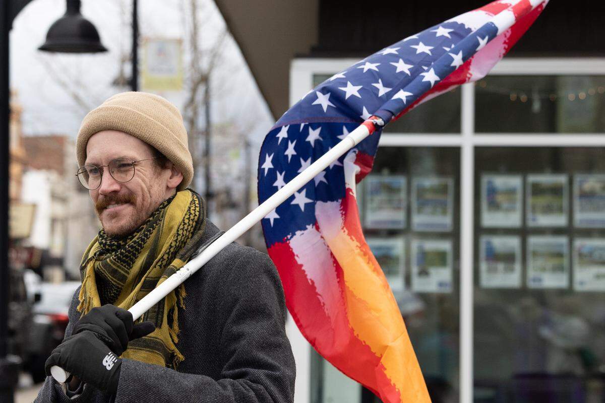 Danny Gula of Belleville holds an American flag during a demonstration at Belleville’s Public Square on Saturday, Jan. 10.