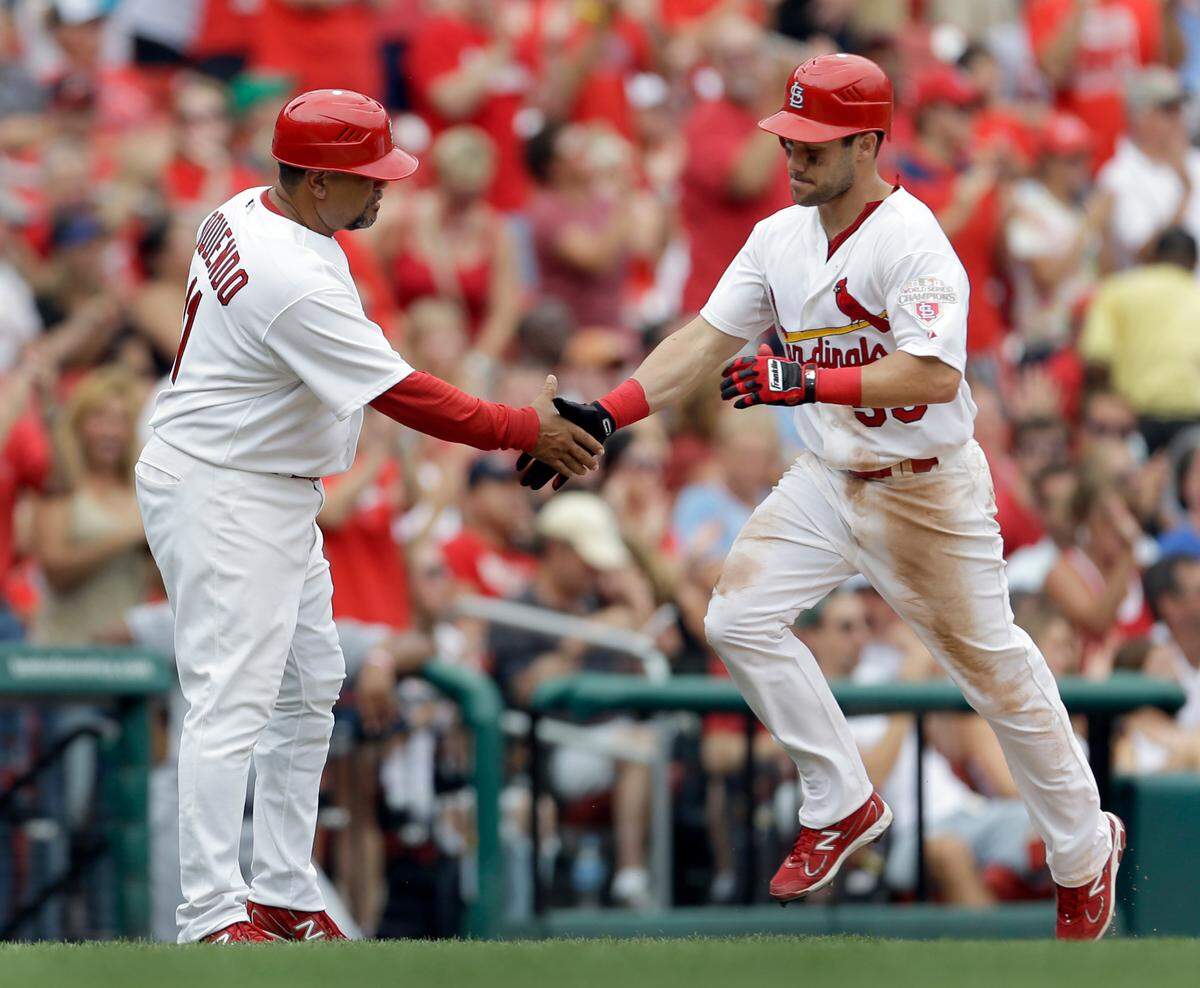 Skip Schumaker, being congratulated by Jose Oquendo after a home run in 2012, is a candidate to fill the Cardinals’ vacant manager’s job. (AP Photo/Jeff Roberson)