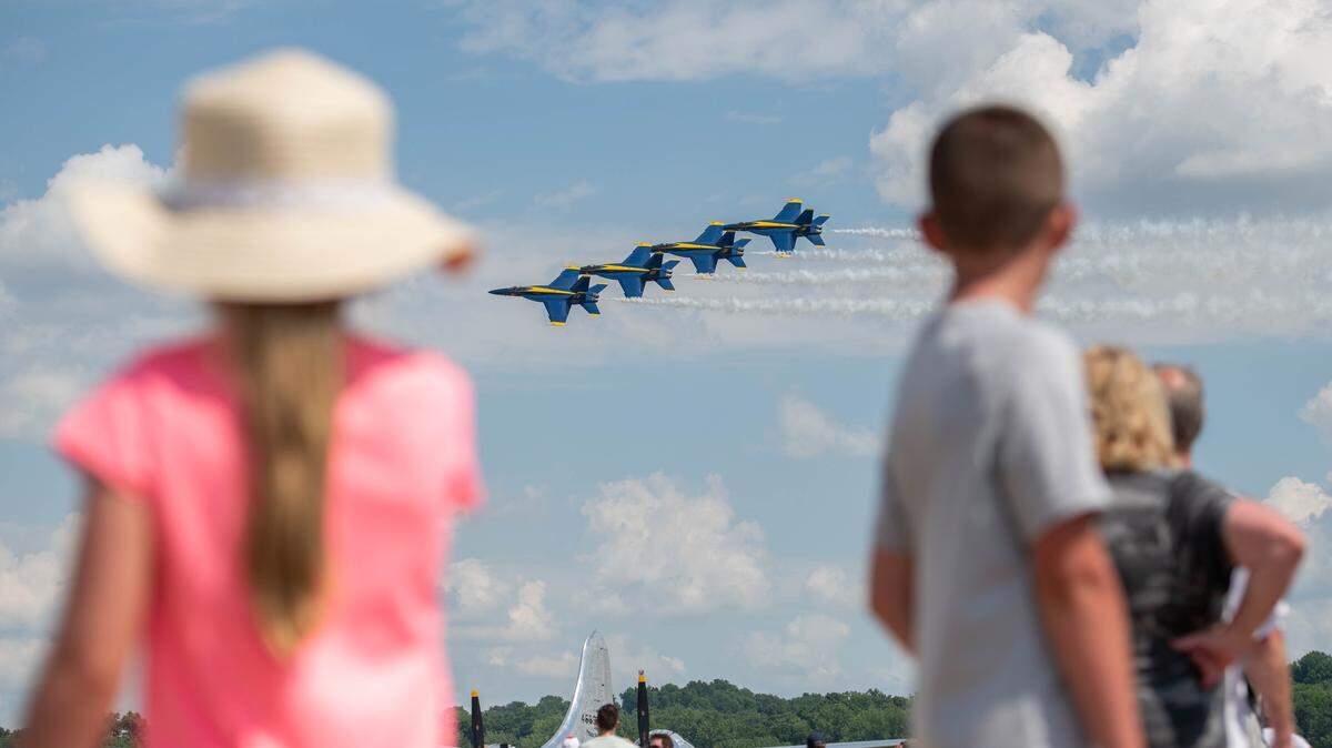 Two children watch as the U.S. Navy Blue Angels fly during an airshow June 11, 2022, in St. Louis. The Blue Angels team has flown for more than 500 million fans since its creation in 1946 and will take part in an airshow Saturday, May 13 and Sunday, May 14 on Scott Air Force Base.