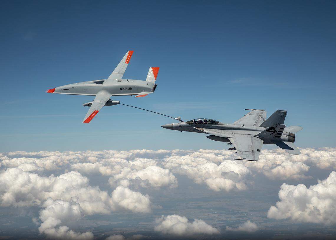 An unmanned MQ-25 aircraft, left, delivers fuel to an U.S. Navy F/A-18 Super Hornet jet fighter in June during an aerial test that originated at MidAmerica St. Louis Airport in Mascoutah.