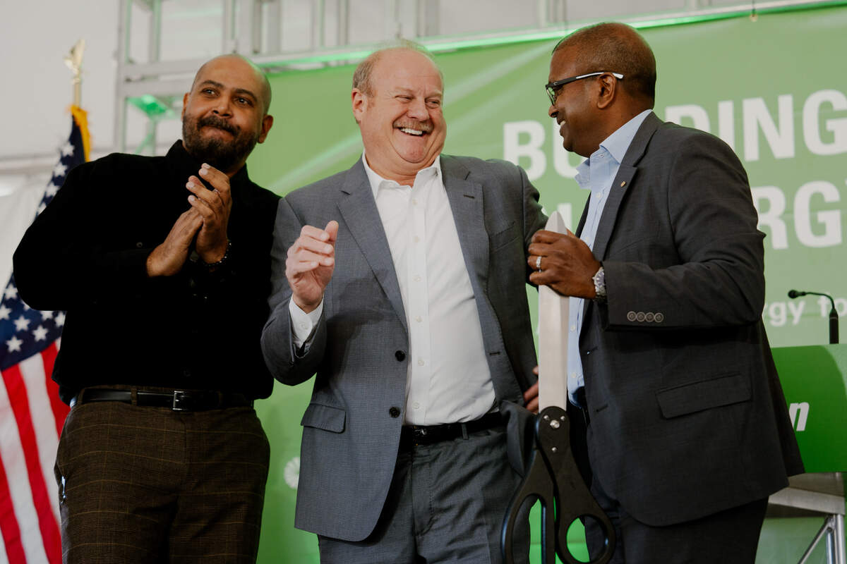 St. Clair County Chairman Mike Kern, center, reacts after Ameren Illinois President Lenny Singh cuts a ribbon during the grand opening of the newly built solar energy farm on Tuesday, Nov. 19, 2024, in East St. Louis.
