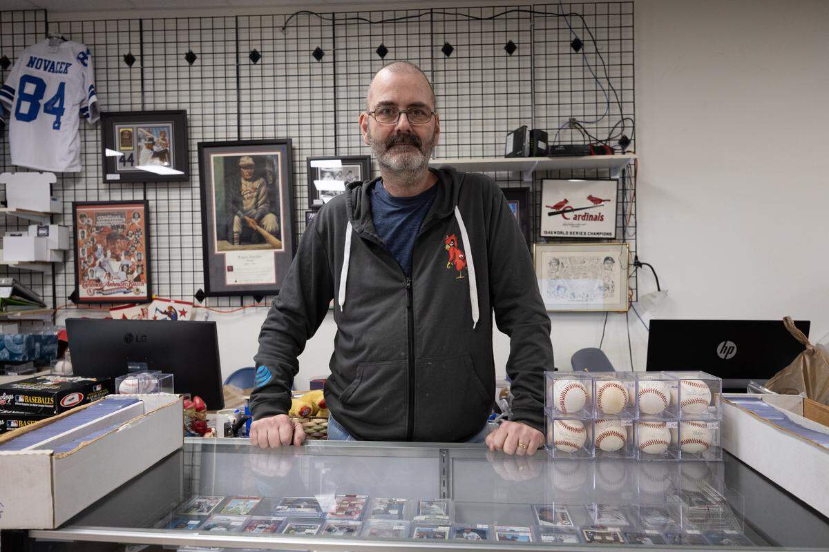 Jim Miller, owner of the Collector’s Corner stands near his baseball card display in downtown Belleville. A $9,000 Jackie Robinson baseball card was stolen from the store on Tuesday but found Wednesday in a Missouri resale shop that features collectibles.