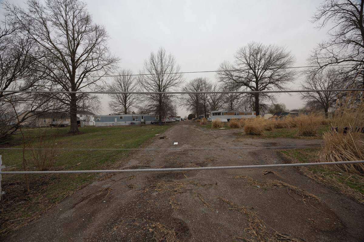 Downed power lines preventing cars from accessing the Parkview Trailer Park in O’Fallon after a possible tornado passed through Friday night.
