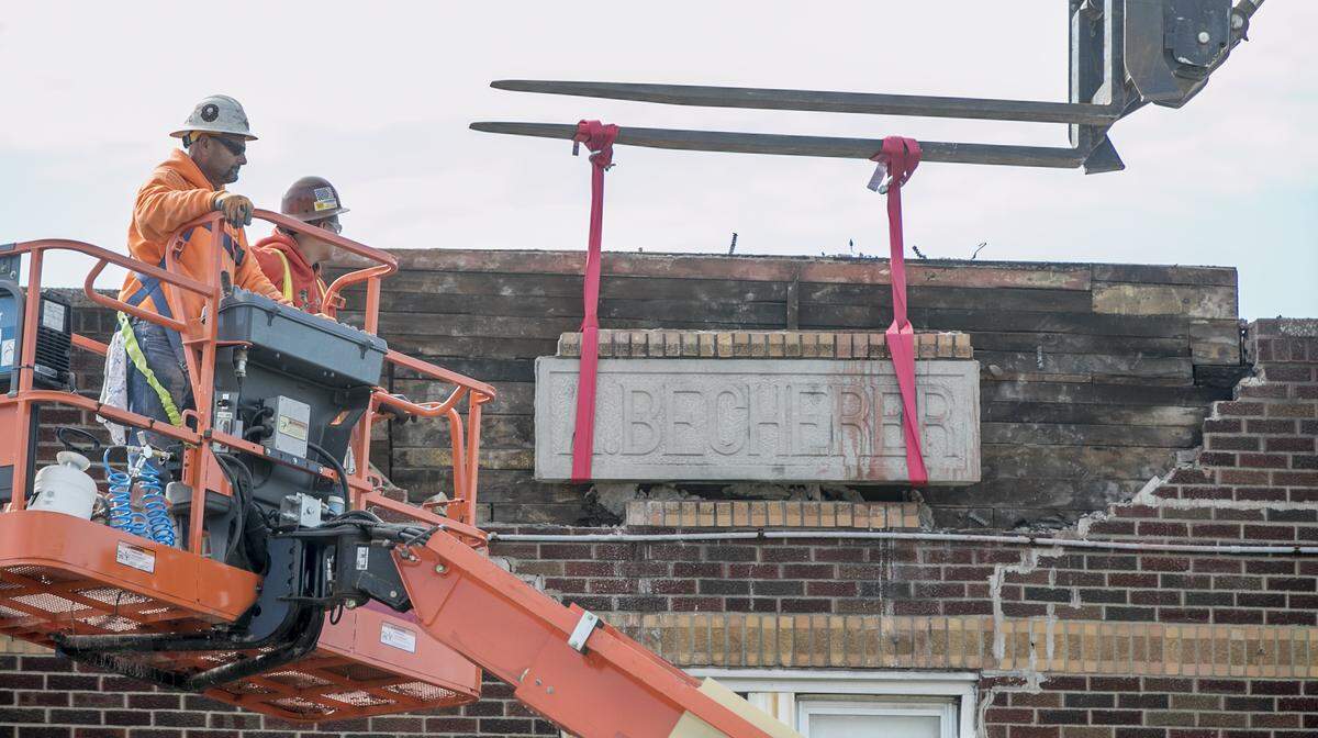 Workers remove a stone with the name “A. Becherer” on Wednesday before demolishing the former Dandy Inn building, which dates back to 1933. It first housed Becherer’s Tavern, owned by Adam Becherer.
