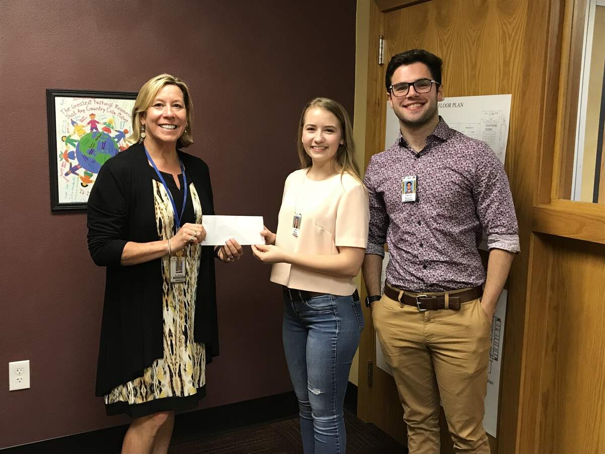 From left, O’Fallon Township High School District 203 Superintendent Darcy Benway accepts the donation from Claire Wilcox and Patrick Murphy, OTHS students who just graduated last week and helped spearhead the formation of the March For Our Lives O’Fallon chapter with other students. The donation will be earmarked for additional active shooter training for faculty and staff to be coordinated with the O’Fallon Police Department, as well as additional training for security personnel at OTHS.