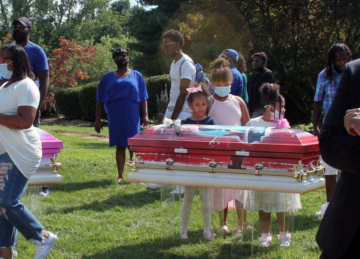 Children look at 4-year-old Jabari Johnson’s coffin during graveside services that took place Aug. 21, 2021 at Sunset Gardens of Memory Cemetery Millstadt. DJabari was one of five children, all siblings, who died in an Aug. 6, 2021, fire at their East St. Louis home.