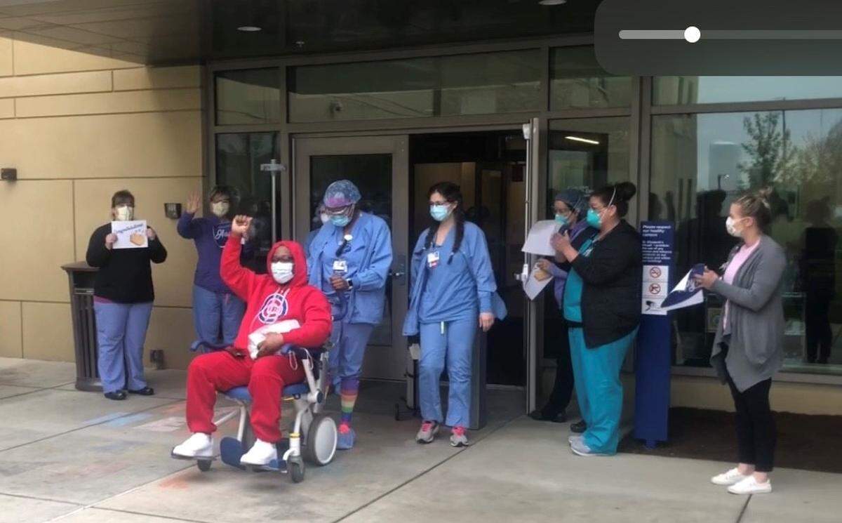 Health-care workers, family and friends cheer as Clifford McIntyre, 49, of Glen Carbon, is discharged from St. Elizabeth’s Hospital in O’Fallon in mid-April after his COVID-19 treatment, which included time on a ventilator.