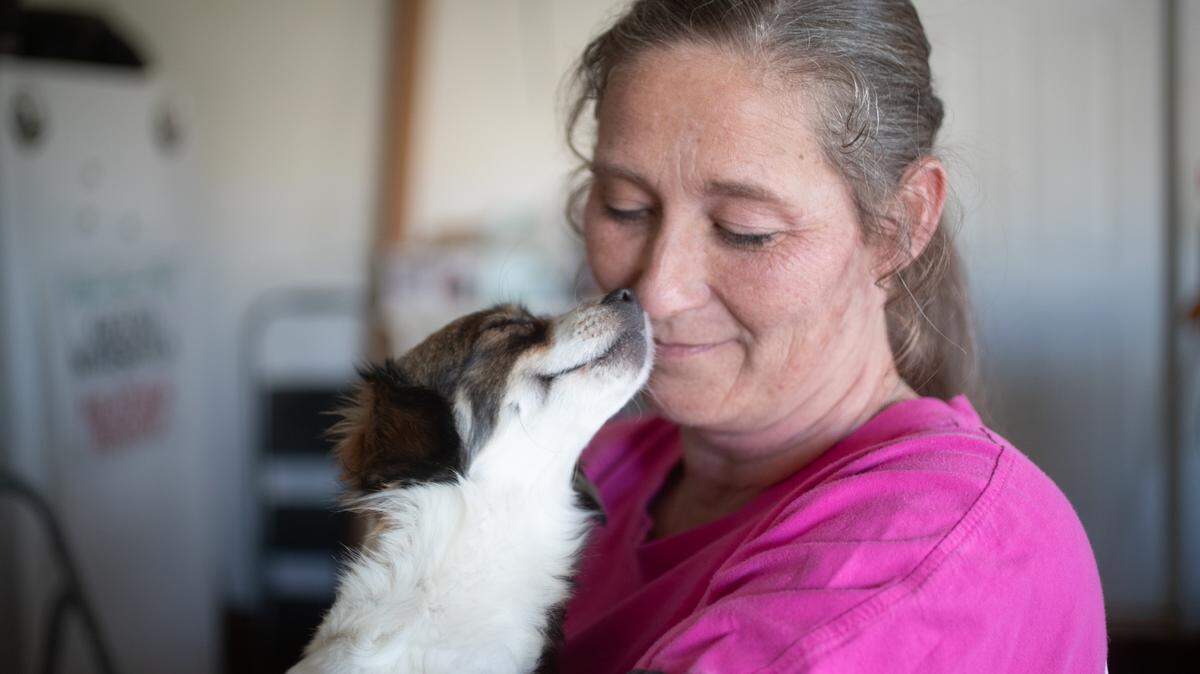 Ashley Bishop of Bishop Small Dog Rescue in Waterloo cuddles with a pregnant dog in this 2025 photograph that earned BND photographer Joshua Carter an award for feature photography.