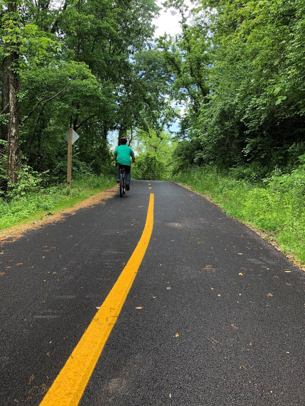A biker uses the new segment of the MetroBikeLink trail, 3.5-mile paved trail running from Fairview Height’s MetroLink stations to the Memorial MetroLink Station in Belleville.
