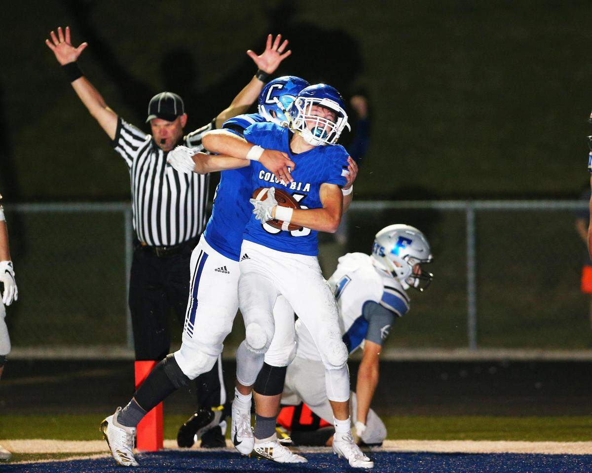 Columbia’s Ronnie Hunsaker and Chase Napier celebrate after Hunsaker’s game-winning touchdown run late in the fourth quarter of their Cahokia Conference showdown with Freeburg Friday night in Columbia.