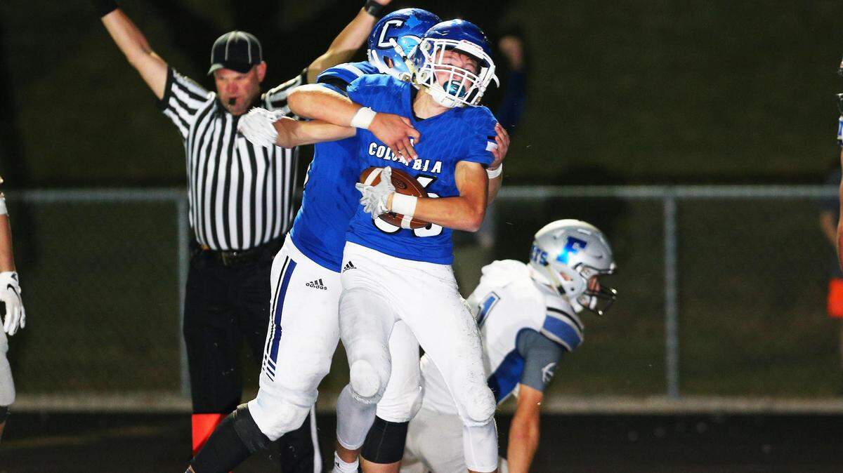 Columbia’s Ronnie Hunsaker and Chase Napier celebrate after Hunsaker’s game-winning touchdown run late in the fourth quarter of their Cahokia Conference showdown with Freeburg Friday night in Columbia.