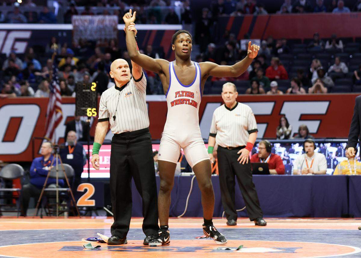 East St. Louis’s Pierre Walton has his hand raised after defeating Montini’s Santino Tenuta in the Class 2A 165-pound championship match at the IHSA Individual Wrestling State Finals on Saturday.