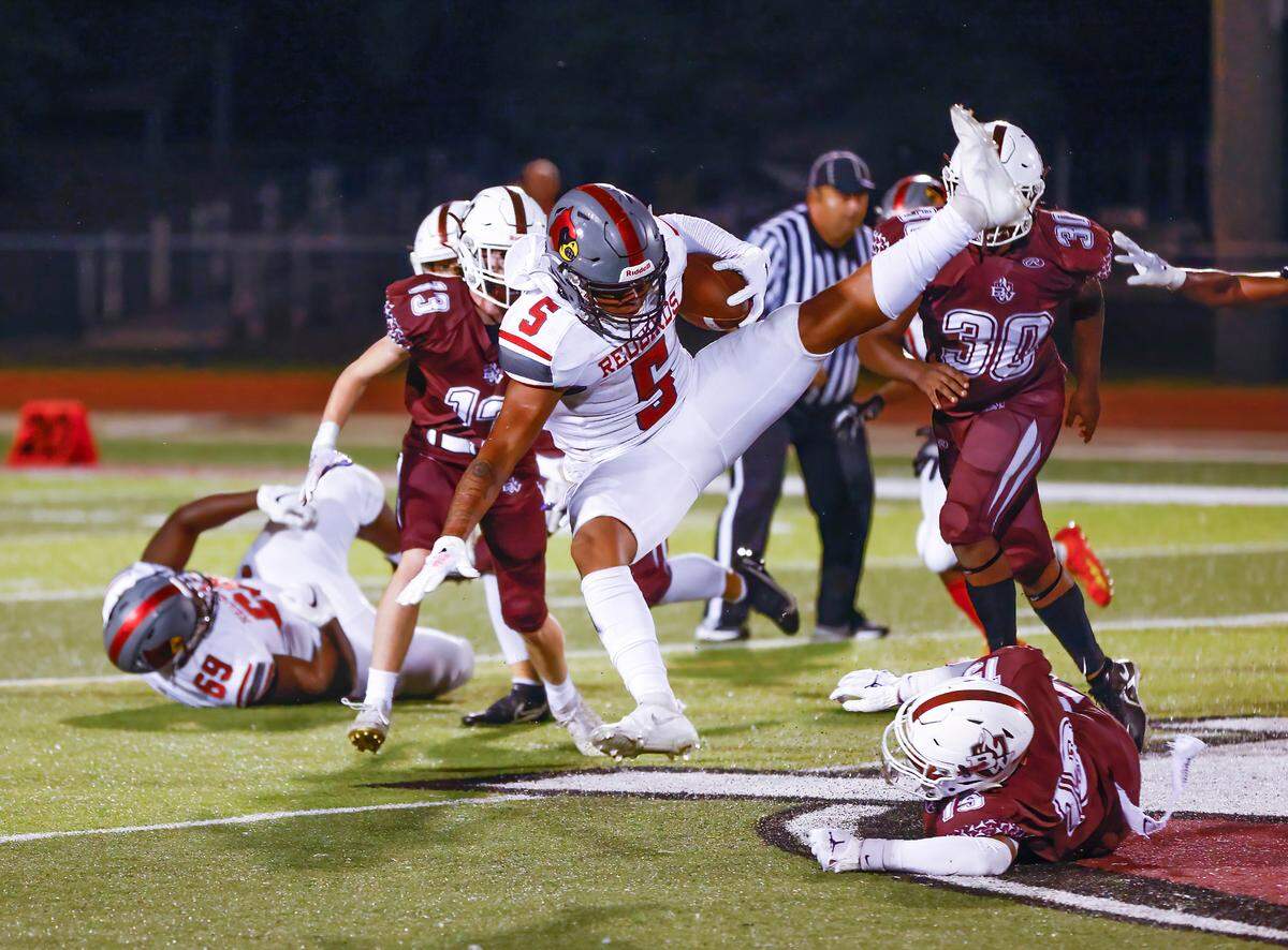 Alton’s Keith Gilchrese carries the ball against Belleville West during a Southwestern Conference game Friday, Sept. 16. The Redbirds ultimately prevailed 28-7.
