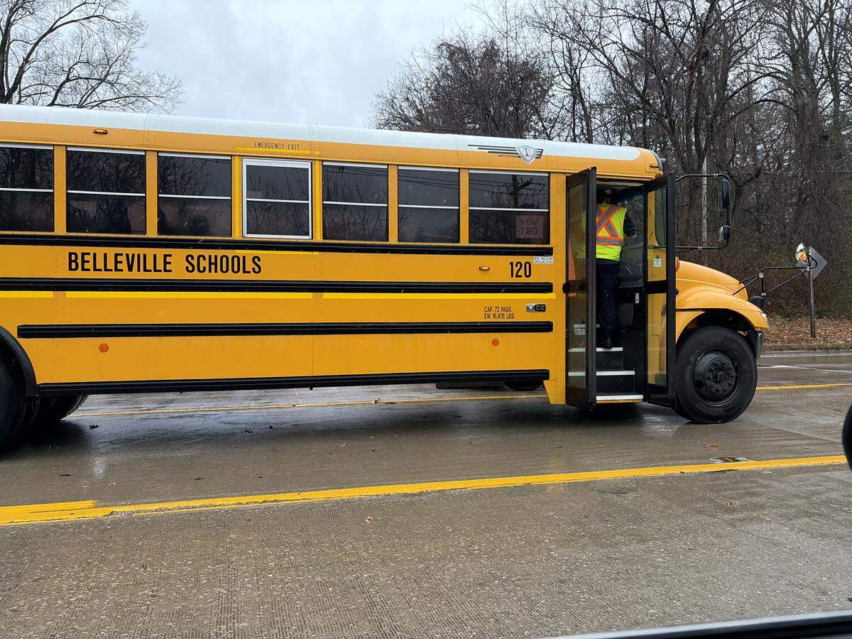A first responder checks in with students on a Belleville school bus after a minor accident on Illinois 159, just north of the stoplight at Huntwood Road in Swansea on Thursday.