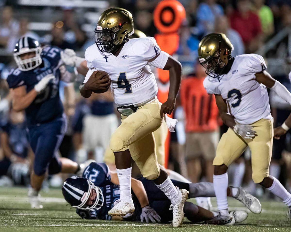 Althoff’s Braylon Grayson carries the ball against Mater Dei on Friday night. Grayson and the Crusaders ultimately posted a 13-7 road victory.