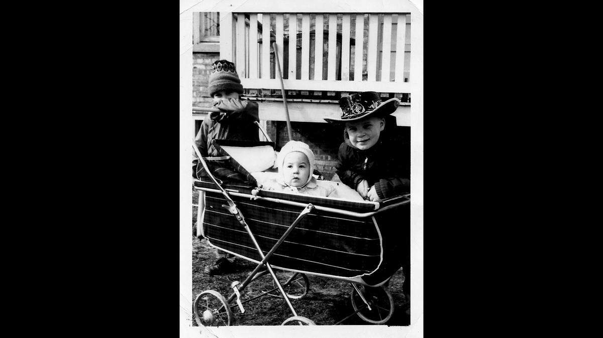 The Rev. Michael G. McGovern peeks out of a baby carriage with his brothers, Jerome, left, and Richard, in the mid-1960s. He has seven siblings.