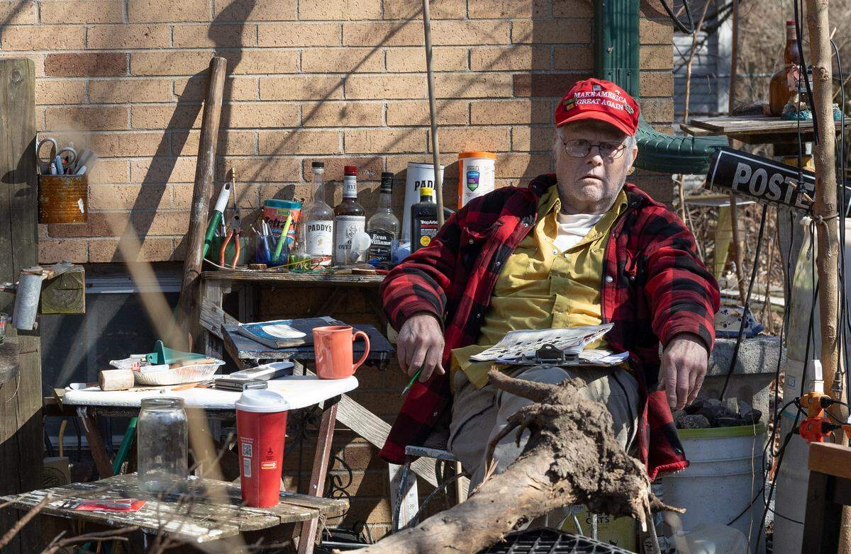 Belleville resident Stewart Lannert is shown sitting in his yard in February, around the time a municipal court judge issued an order to allow the city to clean up his property if he didn’t do it.